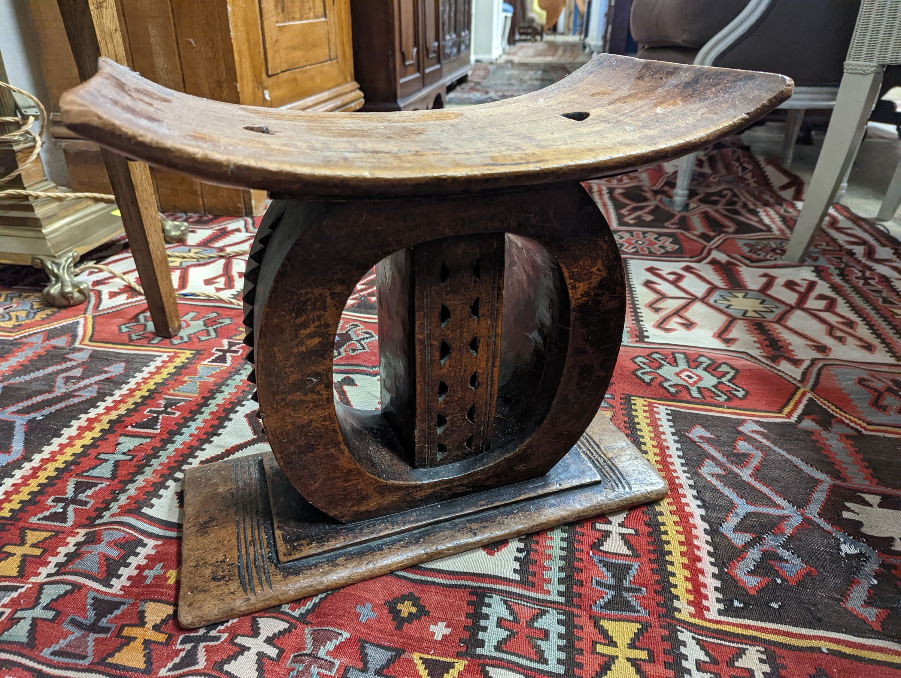 Two African carved hardwood stools, larger length 43cm, depth 19cm, height 37cm